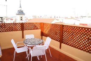 eine Terrasse mit einem Tisch und Stühlen auf dem Balkon in der Unterkunft Cálfred Iglesia Santa Teresita in Logroño