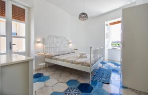 a bedroom with a bed and a blue floor at Ciutat Alghero in Alghero