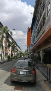 a car parked on the side of a city street at Abani Inn in Jomtien Beach