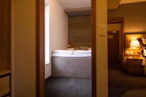 a hotel room with a bed in the background at Hotel Marathon in Senec +32 photos