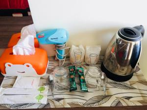 a table with a coffee maker and a blender at Thani Residence in Chon Buri