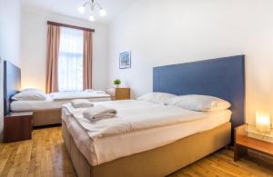 Postel nebo postele na pokoji v ubytování V Lesíčku Residence