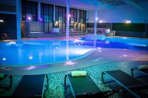 a large swimming pool at night in a hotel at Village Hotel Nottingham in Nottingham