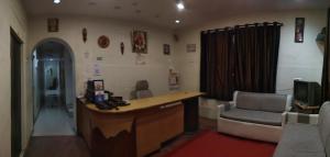 a doctors office with a desk and a chair at Godavari Lodge in Solapur
