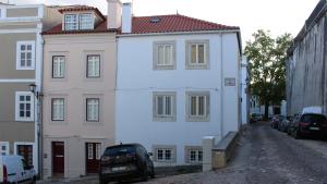 a white building with a red roof on a street at São Bento na Alta St Benedict Uptown in Coimbra