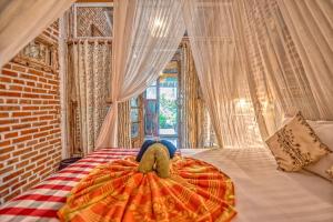 מיטה או מיטות בחדר ב-Santhiku Hotel & SPA