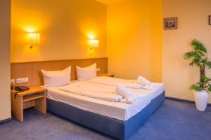 Postel nebo postele na pokoji v ubytování Hotel Wilder Mann