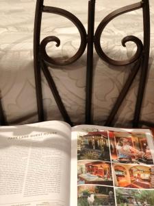 an open book on top of a bed at Park Lane Guest House in Austin