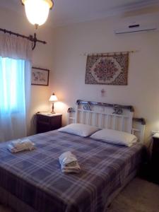 a bedroom with a bed with a hat on it at Pension Panos in Agios Dimitrios
