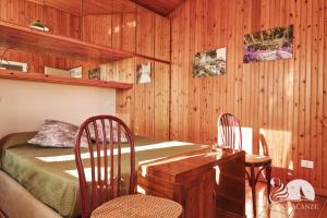 a bedroom with a bed and a table and chairs at Villa Solelago Exclusive in Lonato