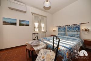 a bedroom with a bed and a table and a chair at Villa Solelago Exclusive in Lonato +66 photos