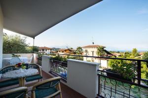 a balcony with a table and chairs and a view at Villa Solelago Exclusive in Lonato