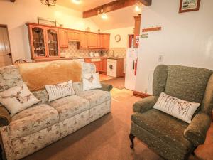 a living room with a couch and two chairs at Piggery Place in Buxton