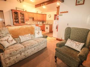 a living room with a couch and two chairs at Piggery Place in Buxton