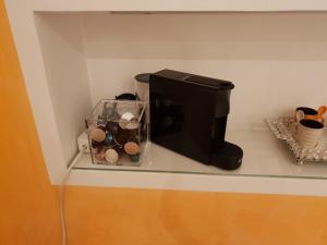 a computer monitor sitting on a shelf with a cup at Gästezimmer Heßdorf in Heßdorf