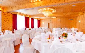 a banquet hall with white tables and white chairs at Sorell Hotel Sonnental in Dübendorf