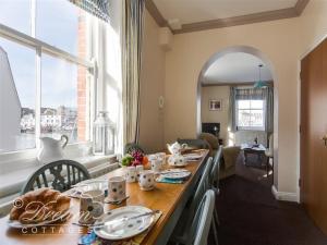 a kitchen with a table with dishes on it at Buccaneer Cottage in Weymouth