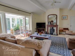 a living room with a couch and a table at Harbour View Bungalow in Weymouth