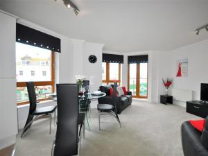 a living room with a table and chairs and a couch at Old Harbour View in Weymouth
