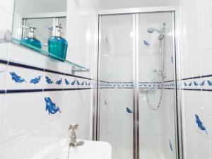 a bathroom with a shower and a sink at Buccaneer Cottage in Weymouth +15 photos