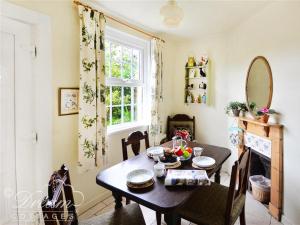 a dining room with a table and a window at Pippins in Dorchester