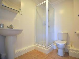 a bathroom with a shower and a toilet and a sink at Old Harbour View in Weymouth +13 photos