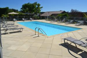 a large swimming pool with chairs at Camping les Silhols in Lagorce