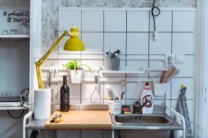 a kitchen with a sink and a counter top at a SZOBA apartman in Pécs +28 photos