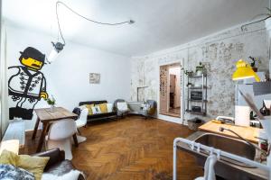 a living room with a couch and a table in it at a SZOBA apartman in Pécs