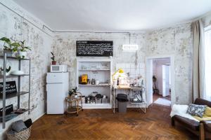 a kitchen with a refrigerator and a table in a room at a SZOBA apartman in Pécs