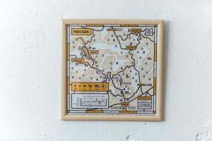 a framed picture of a map on a wall at a SZOBA apartman in Pécs