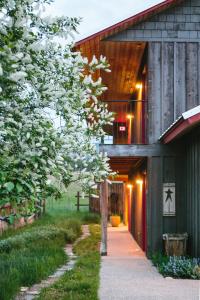 a barn house with a walkway leading to the entrance at Mt Gardner Inn in Winthrop