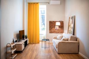 a living room with a couch and a television at Charming apartment in the historic district of Tbilisi in Tbilisi City