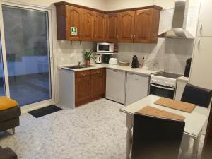 a kitchen with wooden cabinets and a white appliances at Mar de Prata in Maia