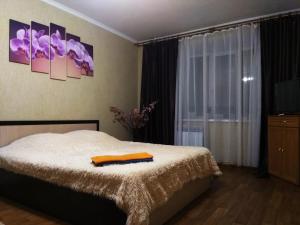 Кровать или кровати в номере Apartment Proezd Rakhmaninova 3
