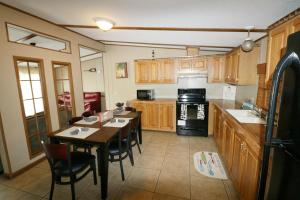 a kitchen with wooden cabinets and a table and chairs at Island Club #22 in Put-in-Bay