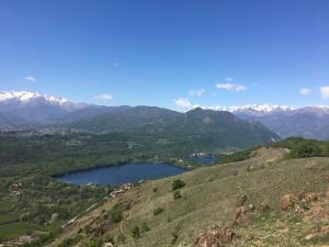 a view of a mountain range with a lake at Hotel Des Alpes in Rosta