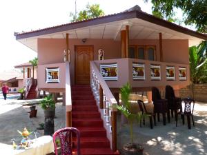 a small house with stairs leading up to it at pesalai plvillas in Pesalai