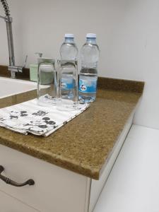 two bottles of water sitting on a counter at סויטה בלב המדבר. in Beʼer Ora