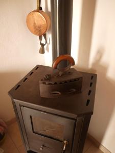 a metal stove with a pot on top of it at Holiday Home Ruža in Mirce