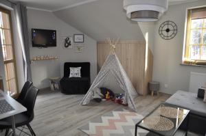 TV a/nebo společenská místnost v ubytování Apartament Lesne Wzgorze