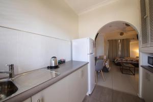 a kitchen with a stove, sink, and refrigerator at Tuncurry Motor Lodge in Tuncurry