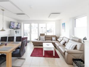 a living room with a couch and a table at Haus Emil in Cuxhaven