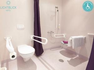 a bathroom with a toilet and a shower at Lichtblick Hotel Garni in Alling