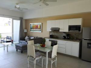 a kitchen and living room with a table and a couch at Depto. Hanna #5 in Bucerías