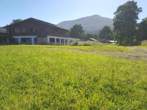 a large field of grass next to a house at Hostal Santa Maria Huife in Pucón