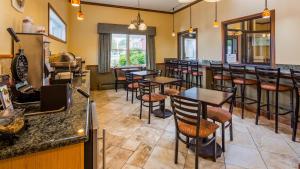 a restaurant with tables and bar stools at Best Western Bennington in Bennington