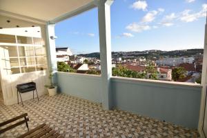a balcony with a view of a city at Casa Pé da Cabra in Coimbra