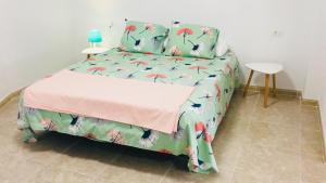 a bedroom with a bed with birds and a table at Sunset house in Los Realejos