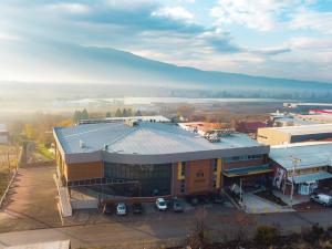 an aerial view of a building with a parking lot at Hotel Amor in Kochani
